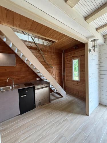 une cuisine avec un escalier dans une maison dans l'établissement Duplex - forêt de Rambouillet, à Gambaiseuil