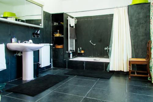 a bathroom with a sink and a tub and a shower at Liiiving in Ofir | Manor Pool House in Fonte Boa