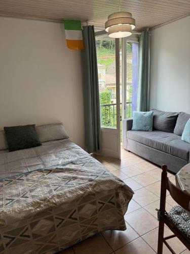 une chambre avec un lit et un canapé dans l'établissement Rennes-les-Bains Studio at foot of thermal baths, à Rennes-les-Bains