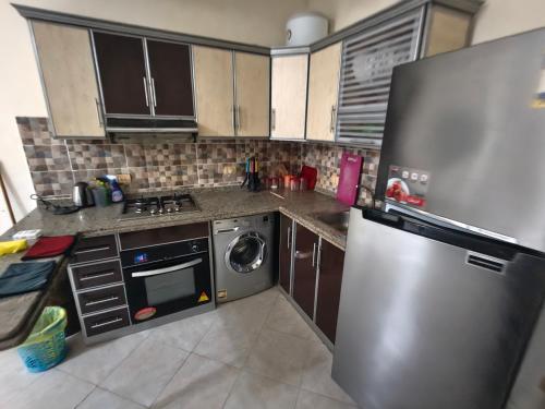 a kitchen with a stainless steel refrigerator and a dishwasher at Apartment in port Ghalib in Port Ghalib