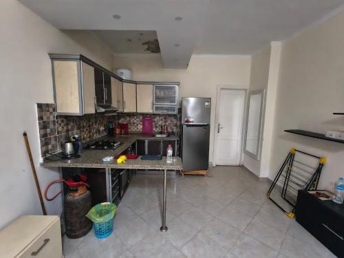 a kitchen with a stainless steel refrigerator in a room at Apartment in port Ghalib in Port Ghalib