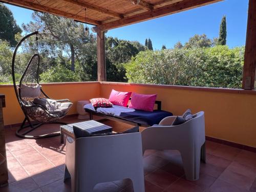 a porch with a couch and a swing at Appartamenti Sterlizia 2 in Lacona