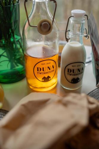 a bottle of mustard and a bottle of milk on a table at DunaTwinhouse in Dömös
