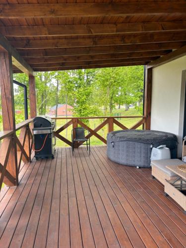 a screened in porch with a bed and a grill at Dom na Skarpie in Małdyty