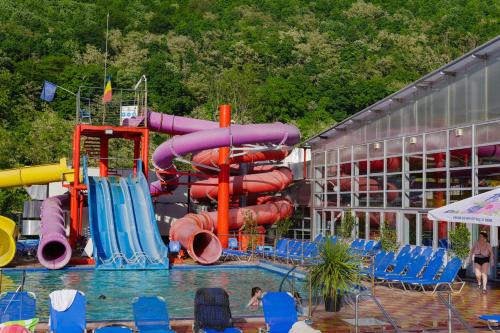 a pool with a water park with a water slide at Complex Balnear Cozia - Corp Oltul in Caciulata