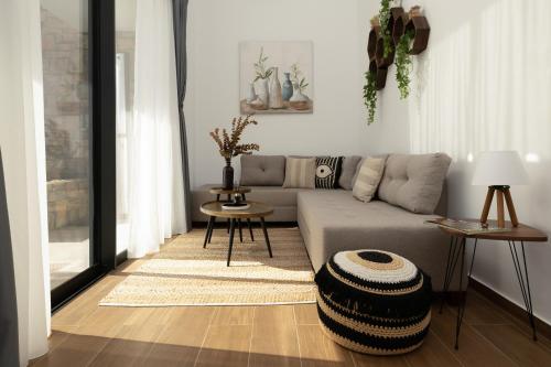 a living room with a couch and a table at Flamingo Living Halkidiki - The Villas in Áyios Mámas