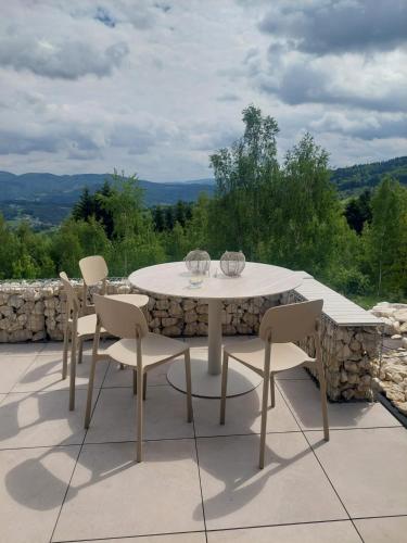 a white table and chairs on a patio at GOLaskowa in Laskowa