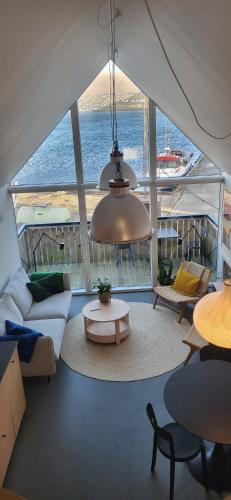 a living room with a view of the water at Charming Apartment in Strendur Faroe Islands, with Stunning Seaview in Strendur