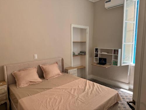 a bedroom with a bed with two pillows on it at Cozy luxury apartment in the heart of Tunis in Tunis