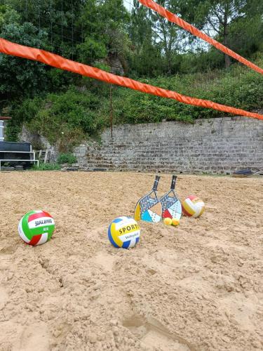 a group of volley balls sitting in the sand at Casetta La Grotta in Canicattini Bagni