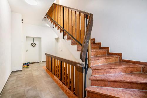 a staircase in a house with wooden railings at Haus Katharina 2 in Inzell