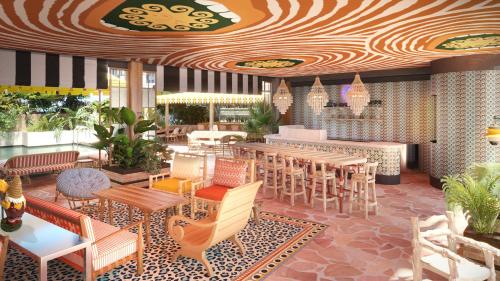a restaurant with tables and chairs and a ceiling at Mama Shelter Singapore Orchard in Singapore