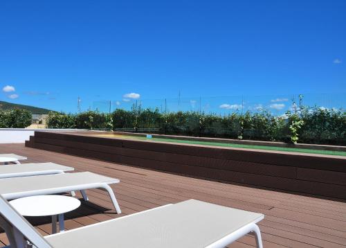 a row of white tables on the roof of a building at Apartaments B-Llobet Sun & Confort in Ibiza Town
