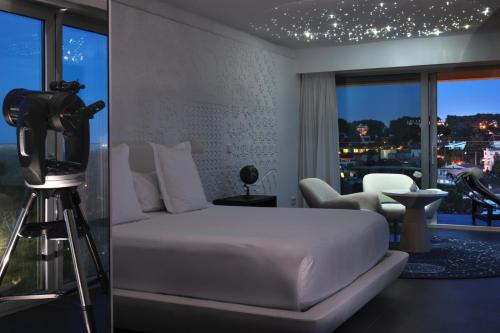 a bedroom with a bed and a camera and a tripod at The Donna Portals in Portals Nous