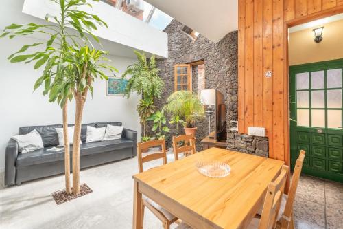 a living room with a wooden table and chairs at Casa Rosi in Frontera
