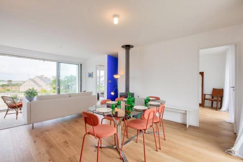 une salle à manger avec une table et des chaises dans l'établissement Vue mer - Maison pour 6 avec balcon - Jardin, à Plouguerneau