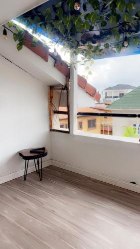 a room with a table in a white room with a window at Eden in Ilado