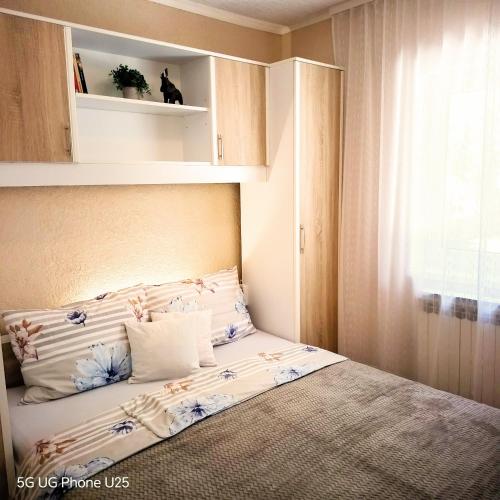 a small bedroom with a bed with avisor at Mario and Maria in Vodnjan