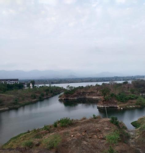 a river with two islands in the middle at Kalyan luxury rooms in Garudeshwar