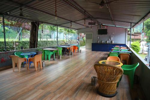 a restaurant with colorful chairs and tables in a room at Moonlight Luxury Camps in Shivpuri
