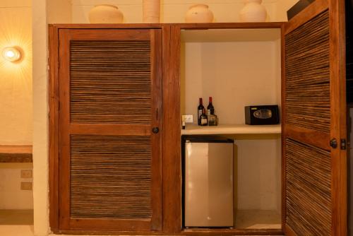 a wooden shutter door in a room with a shelf at Arde La Selva in Santa Fe de Antioquia
