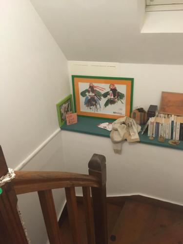 un coin d'une chambre avec une étagère et des livres dans l'établissement Charmante maison de pêcheur bord de mer, à Plougasnou