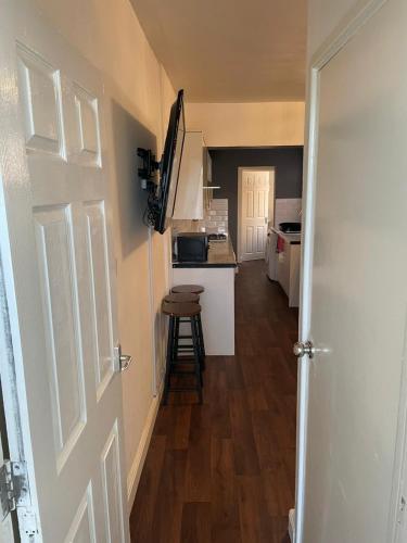 a small kitchen with a counter and a door at Cosy home in the City Centre in Wolverhampton
