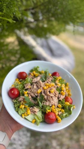 a white bowl of salad with meat and vegetables at Ebru'ca Pansiyon in Selimiye