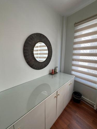 a kitchen with white cabinets and a mirror on the wall at Social House Istanbul in Istanbul