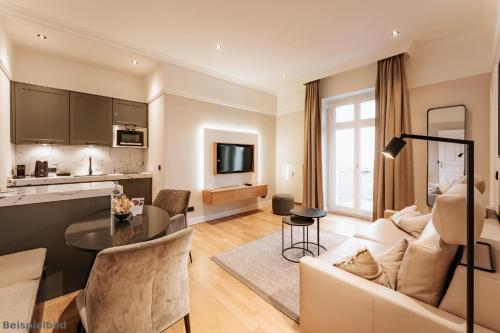 a living room with a couch and a table at Strandhotel Kurhaus Juist in Juist
