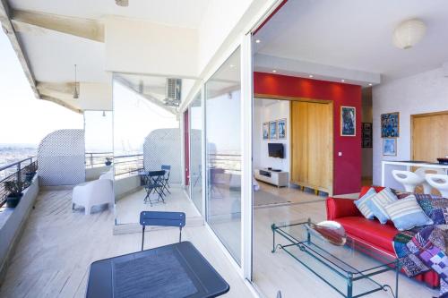 a living room with a red couch and a table at Villa Paquet - Quartier Art Déco in Casablanca