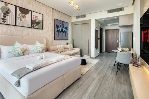 a bedroom with a large bed and a living room at Trendy Studio Apartment in Binghatti Crystals in Dubai