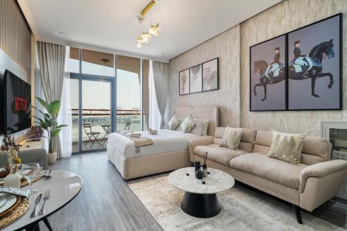 a living room with a couch and a table at Trendy Studio Apartment in Binghatti Crystals in Dubai