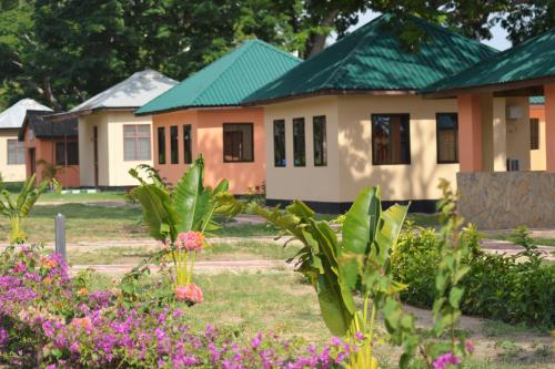 a row of houses with flowers in front of them at Mgulani Lodge Hotel in Dar es Salaam