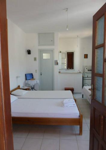 a bedroom with a large white bed in a room at Marietta Studios Patmos in Skala