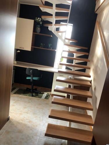 a wooden staircase in a room with a wall at La Casa di Luna in Sant’Angelo