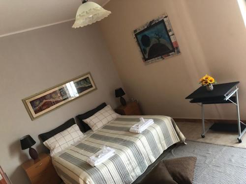 a bedroom with a bed and a desk in it at La Casa di Luna in Sant’Angelo