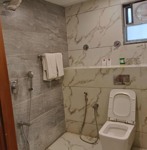 a bathroom with a toilet and a shower at SK Lords Inn Ahmedabad in Ahmedabad