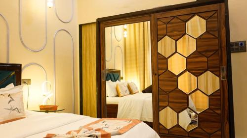 a bedroom with two beds and a mirror at AG Villa in Neral