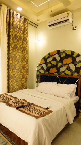 a bedroom with a large white bed with a canopy at AG Villa in Neral