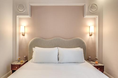 a bedroom with a large bed with white pillows at Hotel Fori Imperiali in Rome