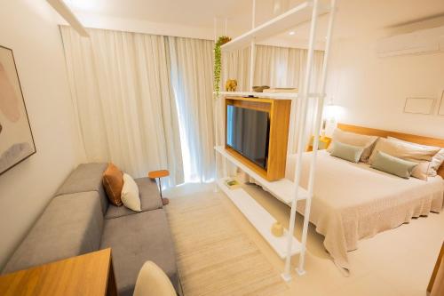 a small room with a bed and a television at 1106 - Estúdio novíssimo com estrutura e conforto in Guarulhos