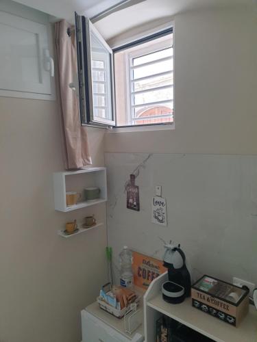 a room with a window and a desk and a table at Corte Verde 5 in Bari