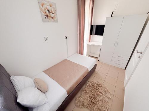 a small bedroom with a bed in a room at Villa Iris in Trbounje
