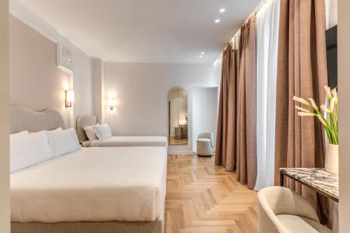 Postel nebo postele na pokoji v ubytování Hotel Fori Imperiali