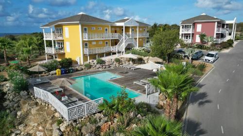 an aerial view of a house with a swimming pool at Chogogo Dive & Beach Resort Curaçao in Jan Thiel