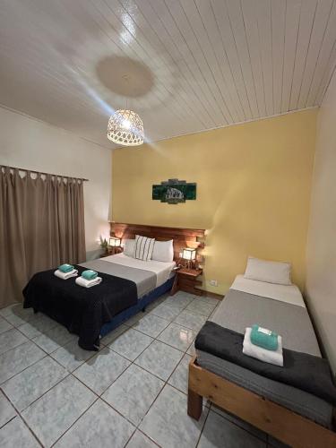 a bedroom with two beds in a room at Hotel Puerto Libertad - Iguazú in Puerto Libertad