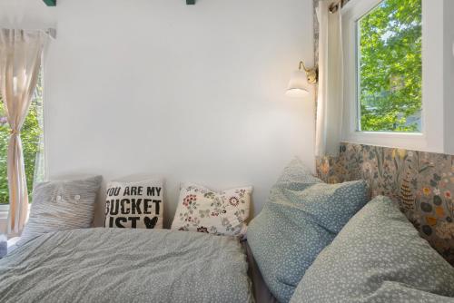 a bedroom with a bed and pillows and a window at Tiny Haus in Fitzen