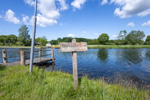 a sign in the grass next to a body of water at Tiny Haus in Fitzen