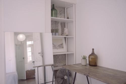 a dining room with a table and a bottle of wine at Light & Airy Historic Centre House with Balconies in Porto